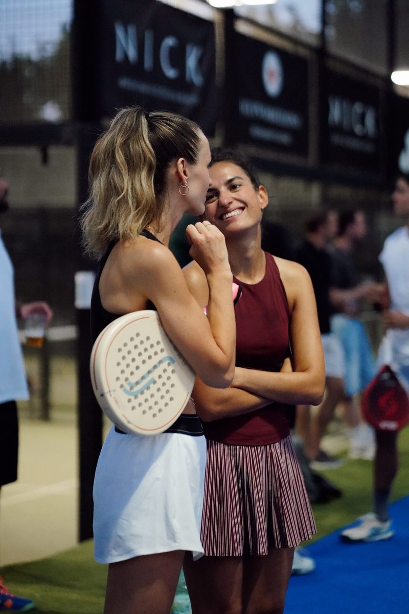 Two players sharing a laugh courtside between matches
