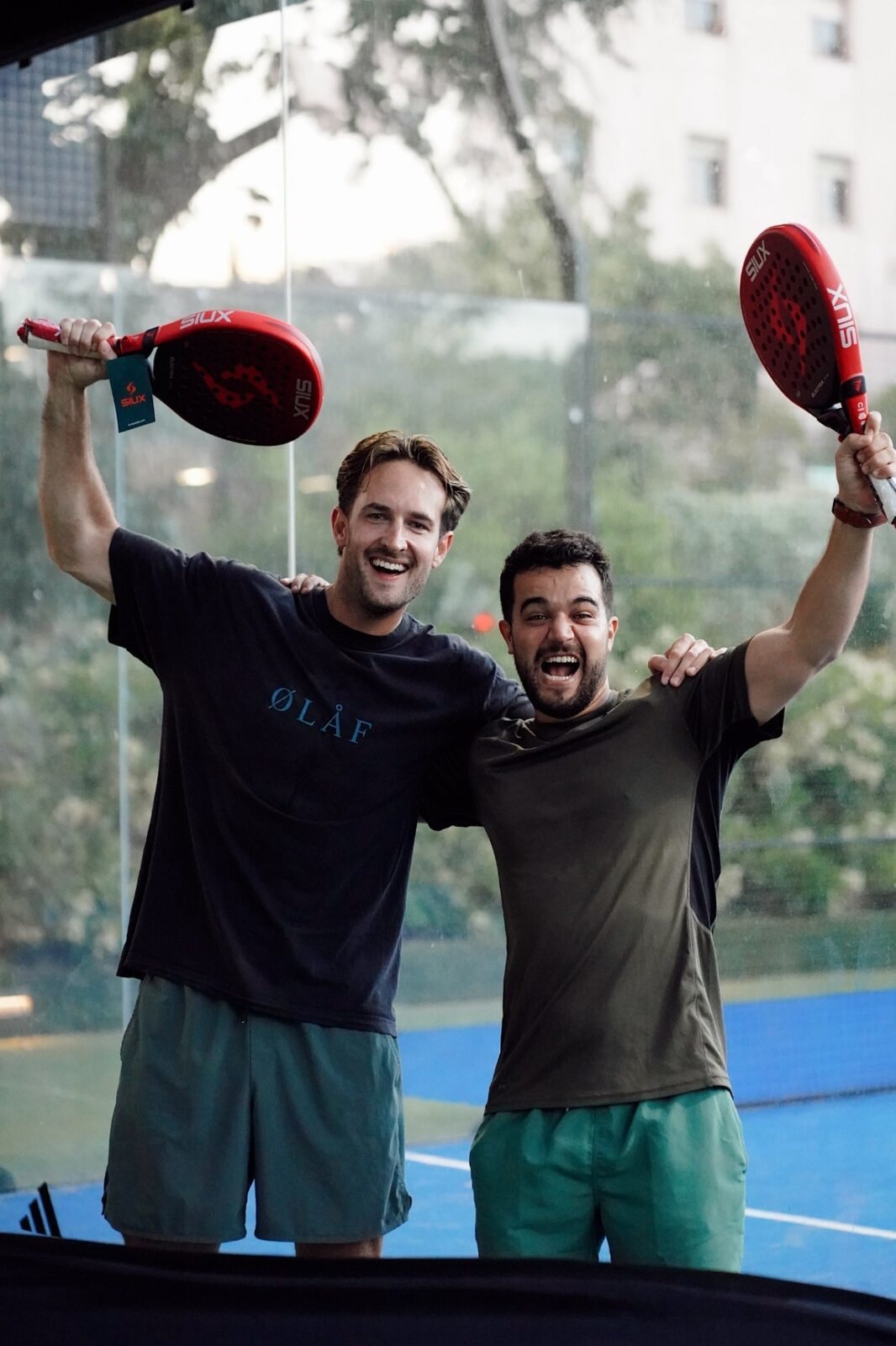 Winning padel pair holding the tournament trophy